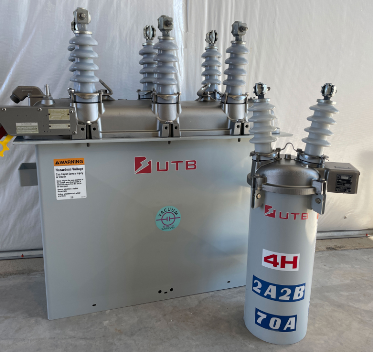 A large transformer with three types of equipment: power cables, circuit breakers, and voltage regulators.