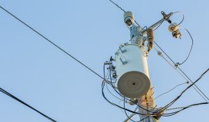 Telephone pole with wires and white phone