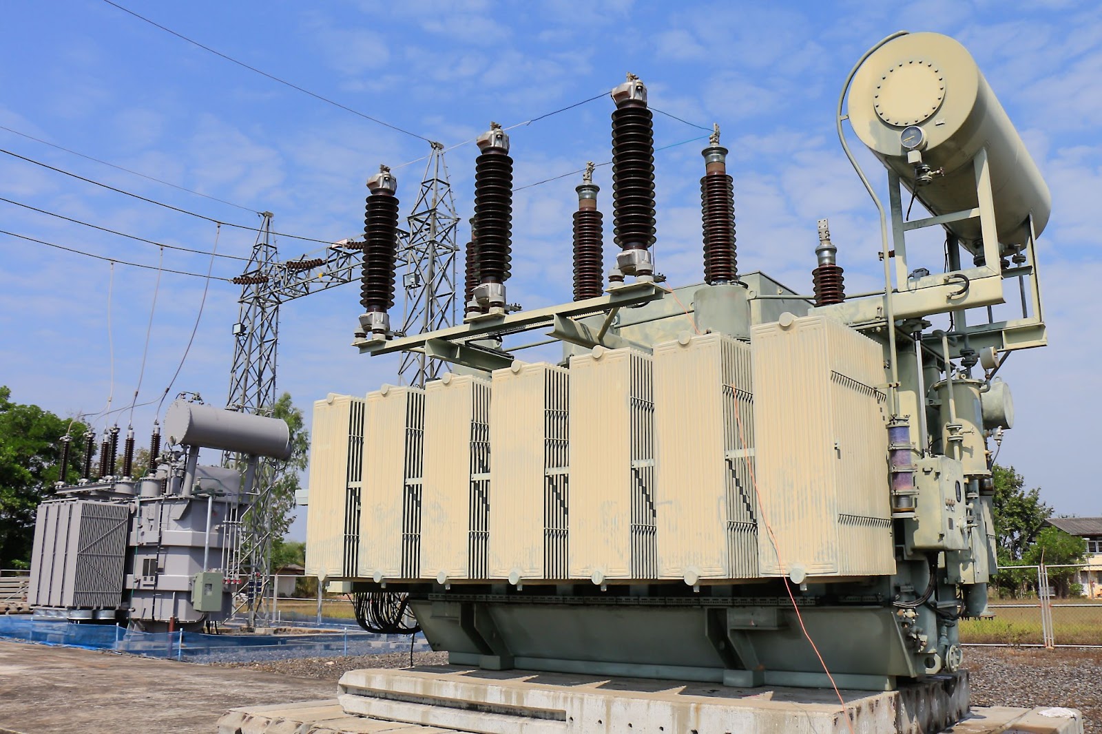 A large transformer with multiple electrical wires, used for transformer safety and substation voltage regulators.