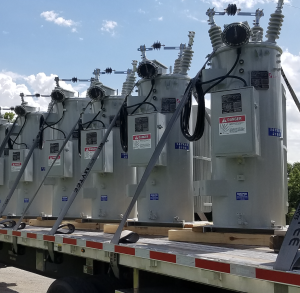 A truck loaded with substantial transformers, crucial for maintaining voltage levels in substations.